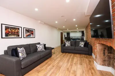 a living room with two couches and a fireplace at Concert Square Apartments By Happy Days in Liverpool