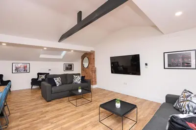 a living room with a couch and a tv at Concert Square Apartments By Happy Days in Liverpool