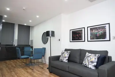 a living room with a couch and a table and chairs at Concert Square Apartments By Happy Days in Liverpool