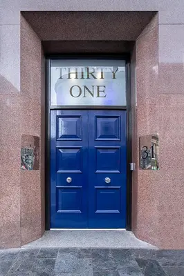 a blue door in a building with a sign above it at Cavern Quarter apartments by The Castle Collection in Liverpool