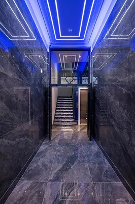a hallway with a blue ceiling and stairs in a building at Cavern Quarter apartments by The Castle Collection in Liverpool