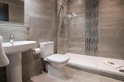 a bathroom with a toilet and a sink and a shower at Cavern Quarter apartments by The Castle Collection in Liverpool