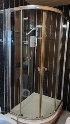 a shower with a glass enclosure in a bathroom at Merginn Guest House in Blackpool