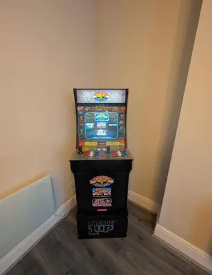 a video game machine in a corner of a room at Withnell Stays - Apartment One - Ground Floor - Retro Gaming Machine in Blackpool