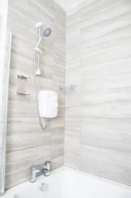 a bathroom with a shower and a sink at Withnell Stays - Apartment One - Ground Floor - Retro Gaming Machine in Blackpool