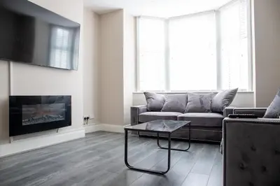 a living room with a couch and a coffee table at Withnell Stays - Apartment One - Ground Floor - Retro Gaming Machine in Blackpool