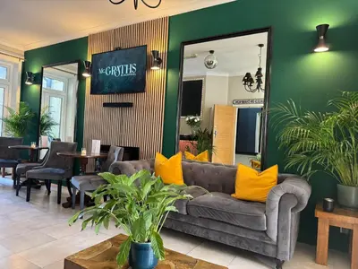 a living room with a couch and yellow pillows at McGraths Hotel & Public Bar in Blackpool