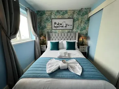 a bedroom with a bed with a bow tie on it at McGraths Hotel & Public Bar in Blackpool