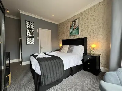 a bedroom with a large bed and a window at McGraths Hotel & Public Bar in Blackpool