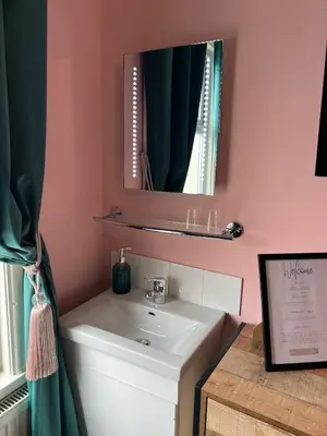 a bathroom with a sink and a mirror at McGraths Hotel & Public Bar in Blackpool