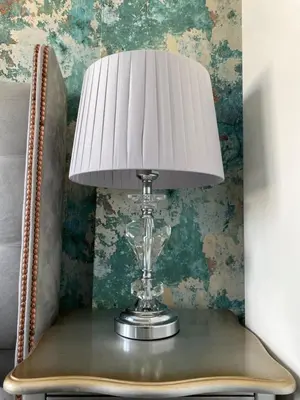 a table with a lamp on top of a chair at McGraths Hotel & Public Bar in Blackpool