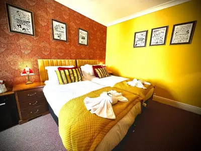 a bedroom with two beds with towels on them at McGraths Hotel & Public Bar in Blackpool