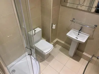 a bathroom with a shower and a toilet and a sink at Entire Seaside Home, Sleeps 8, All en-suite rooms in New Brighton