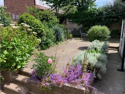 a garden with many different plants and flowers at Entire Seaside Home, Sleeps 8, All en-suite rooms in New Brighton