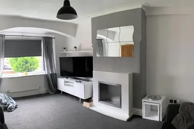 a living room with a television and a fireplace at House - Sleeps 5 - Pet friendly - Garden - Parking in Saint Annes on the Sea
