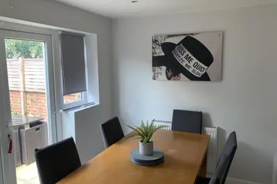 a dining room with a wooden table with chairs at House - Sleeps 5 - Pet friendly - Garden - Parking in Saint Annes on the Sea