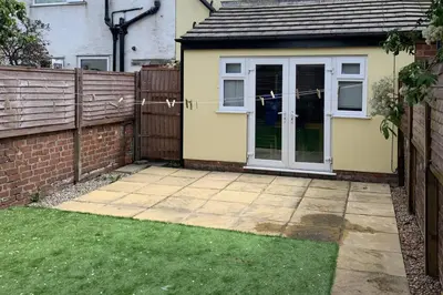 a house with a door and a yard with a fence at House - Sleeps 5 - Pet friendly - Garden - Parking in Saint Annes on the Sea