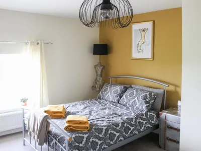 a bedroom with a bed and a chandelier at Hornby Cottage in Saint Michaels on Wyre
