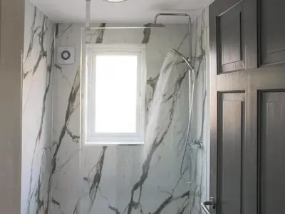 a bathroom with a window and a shower at Hornby Cottage in Saint Michaels on Wyre