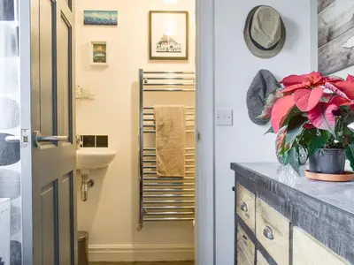 a bathroom with a sink and a towel rack at Hornby Cottage in Saint Michaels on Wyre