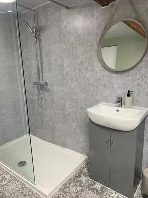 a bathroom with a shower and a sink and a mirror at Blackpool Lodge Apartments in Blackpool