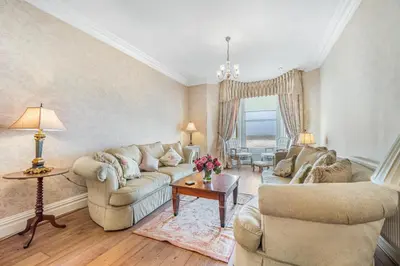 a living room with two couches and a table at Pier View House in Blackpool