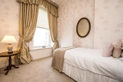 a bedroom with a bed and a window at Pier View House in Blackpool