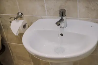 a toilet in a bathroom with water coming out of it at Pier View House in Blackpool