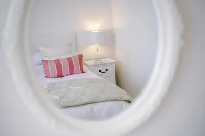 a bedroom with a bed and a mirror at Pier View House in Blackpool