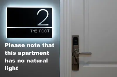 a sign on the door of a door with the root on it at Trueman Court Luxury Serviced Apartments in Liverpool