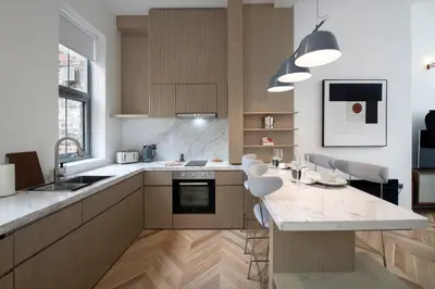 a kitchen with a large island with white counter tops at Trueman Court Luxury Serviced Apartments in Liverpool