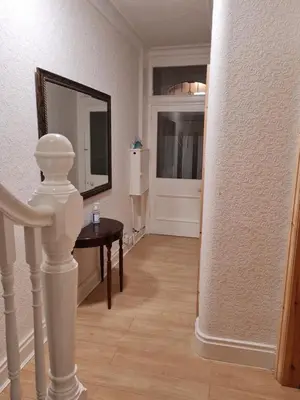 a room with a hallway with a table and a mirror at Cheerful 4-bedroom holiday home close to the Sea in Blackpool