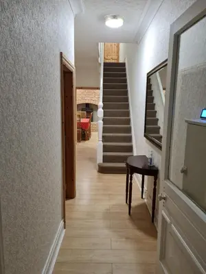 a hallway with a staircase and a stair case at Cheerful 4-bedroom holiday home close to the Sea in Blackpool