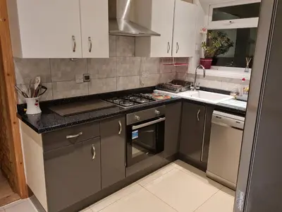 a kitchen with a sink and a stove top oven at Cheerful 4-bedroom holiday home close to the Sea in Blackpool