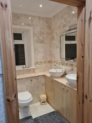 a bathroom with a toilet and a sink and a mirror at Cheerful 4-bedroom holiday home close to the Sea in Blackpool