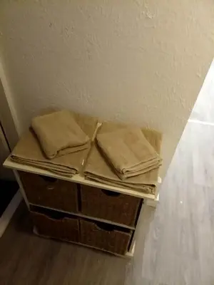 a pile of towels sitting on top of baskets at Litherland Apartment in Litherland