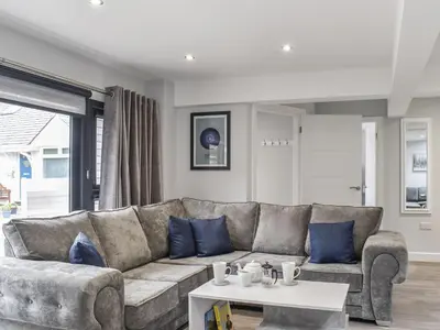 a living room with a couch and a table at Woodgate Cottage in Dalton in Furness