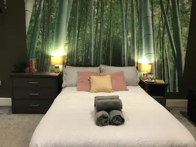 a bedroom with a bed with two towels on it at Contemporary 1 bed studio for comfy stay in Wigan in Wigan