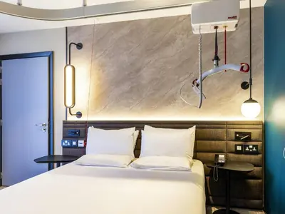 a bedroom with a bed and a basketball hoop on the wall at Novotel Liverpool Paddington Village in Liverpool