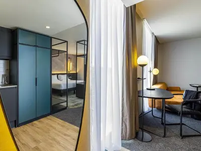 a mirror in a hotel room with a bedroom at Novotel Liverpool Paddington Village in Liverpool