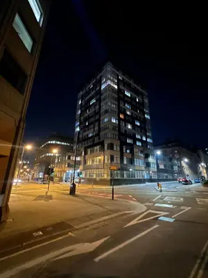 a tall building in a city at night at Luxury Chic Apartments in Liverpool