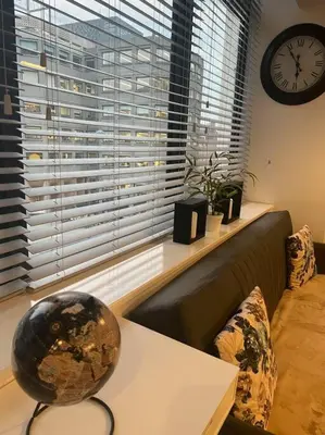 a living room with a couch and a clock on a window at Luxury Chic Apartments in Liverpool