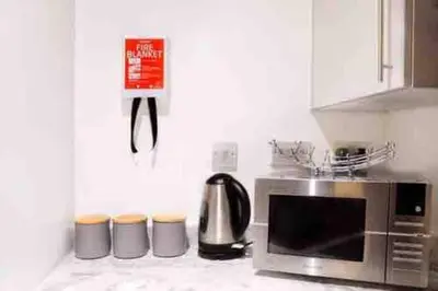 a kitchen counter with a microwave and a coffee maker at Luxury Chic Apartments in Liverpool