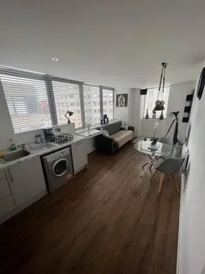 a room with a kitchen and a living room at Luxury Chic Apartments in Liverpool