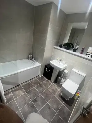 a bathroom with a toilet and a sink at Luxury Chic Apartments in Liverpool