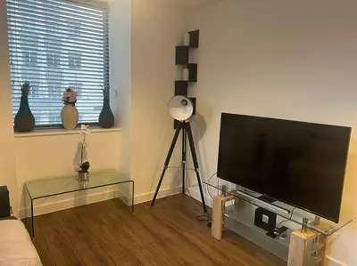 a living room with a large flat screen tv at Luxury Chic Apartments in Liverpool