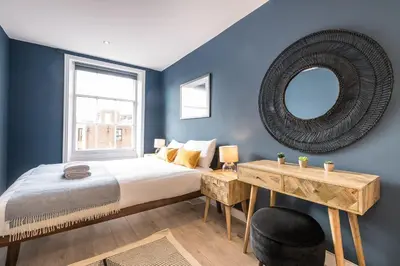 a bedroom with a large bed and a mirror at Host & Stay - The Georgian Quarters at Canning in Liverpool