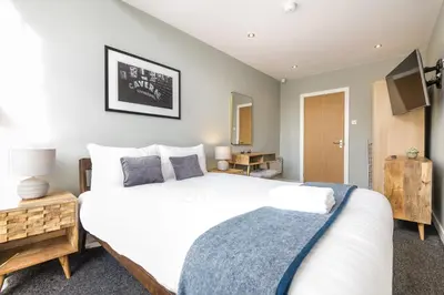 a bedroom with a large white bed and a television at Host & Stay - The Georgian Quarters at Canning in Liverpool
