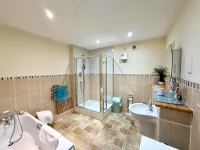 a bathroom with a shower and a sink and a toilet at Apartment 1 in Morecambe