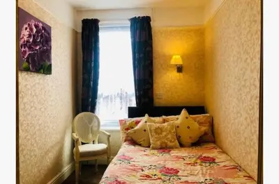 a bedroom with a bed and a window at Dunromin Hotel in Blackpool